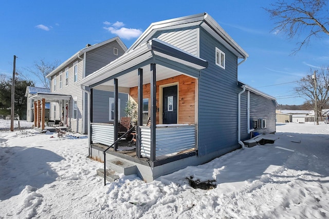 snow covered house with a porch