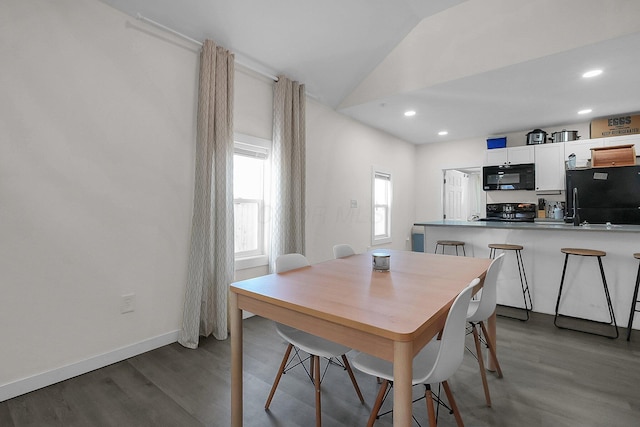 dining area with hardwood / wood-style flooring and lofted ceiling