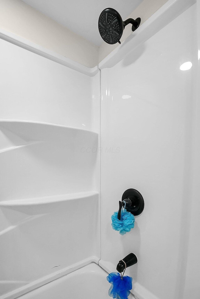 interior details featuring bathing tub / shower combination