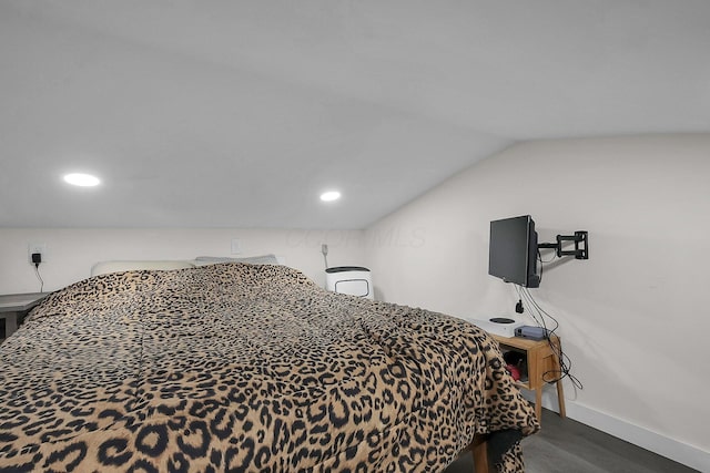 bedroom featuring dark wood-type flooring and vaulted ceiling