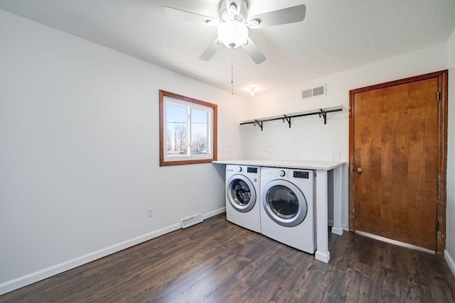 washroom featuring dark wood-type flooring, independent washer and dryer, ceiling fan, and a textured ceiling