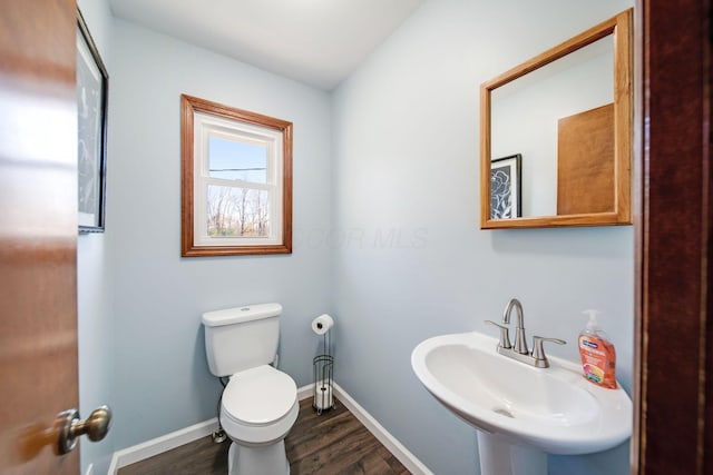 bathroom featuring sink, hardwood / wood-style flooring, and toilet