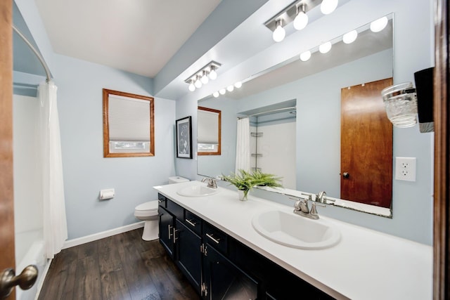 bathroom featuring vanity, hardwood / wood-style floors, and toilet