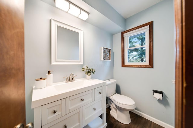 bathroom with vanity, wood-type flooring, and toilet