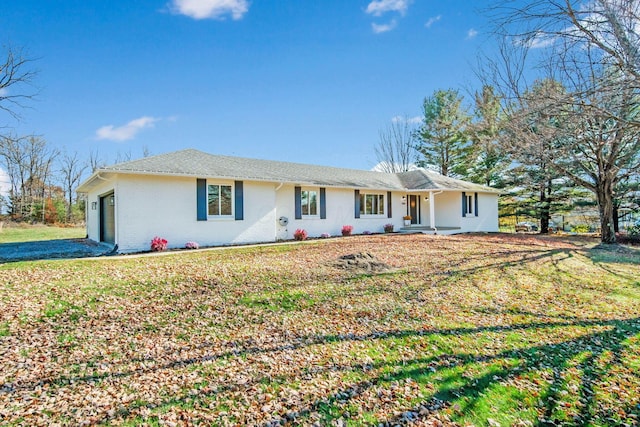 ranch-style house with a garage and a front yard