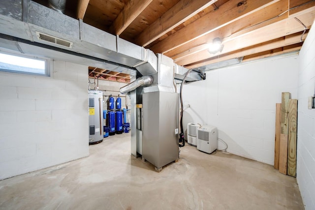 basement featuring electric water heater and heating unit