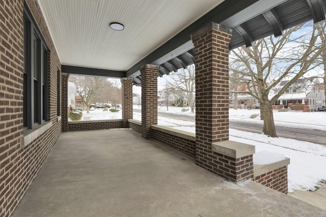 snow covered patio with covered porch