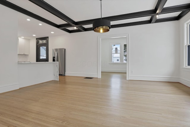 unfurnished living room with beam ceiling, light hardwood / wood-style floors, and coffered ceiling