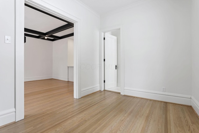 unfurnished room featuring beamed ceiling, light wood-type flooring, ornamental molding, and coffered ceiling