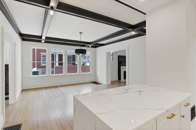 interior space featuring beamed ceiling, white cabinets, hanging light fixtures, and coffered ceiling