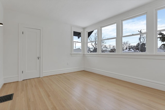 empty room with light hardwood / wood-style floors