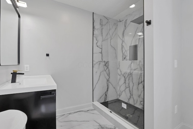 bathroom with a tile shower and vanity