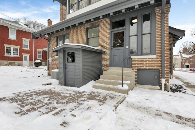 view of snow covered property entrance