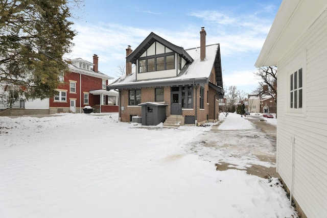 view of snow covered back of property