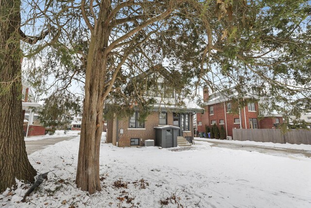 view of snow covered rear of property