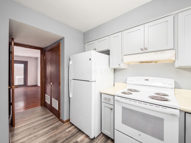 kitchen featuring light wood-type flooring, white appliances, and white cabinetry