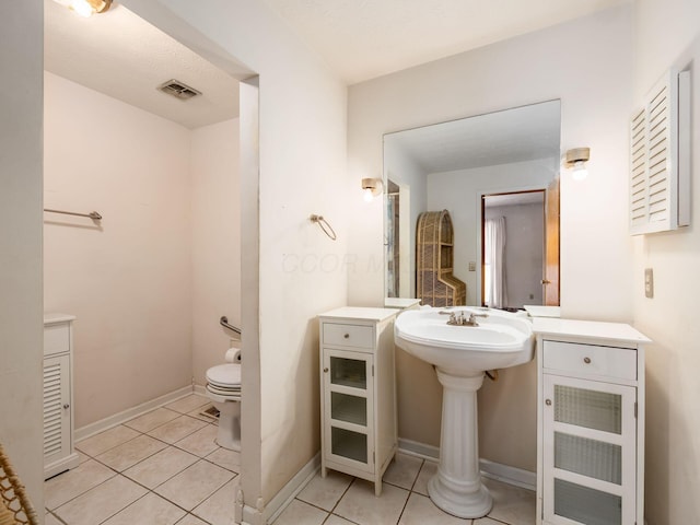 bathroom featuring tile patterned flooring and toilet