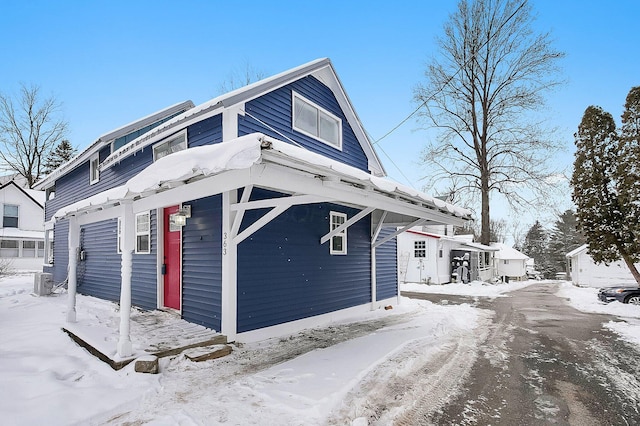 view of snowy exterior featuring cooling unit