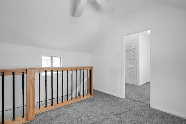 bonus room featuring ceiling fan, vaulted ceiling, and dark colored carpet