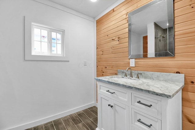 bathroom with vanity and wood walls