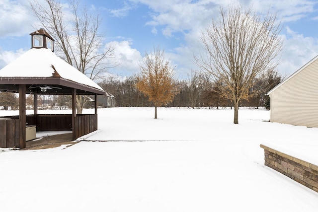 yard covered in snow with a gazebo