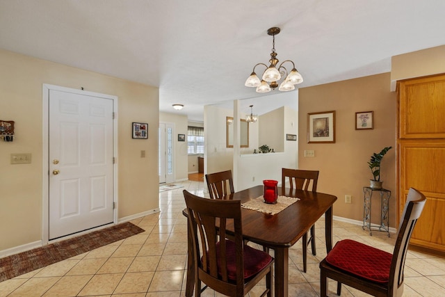 tiled dining area with a chandelier