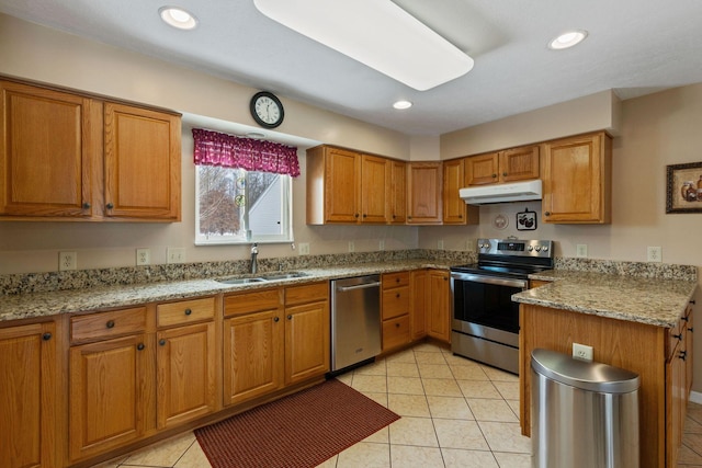 kitchen with sink, light stone countertops, stainless steel appliances, and light tile patterned floors