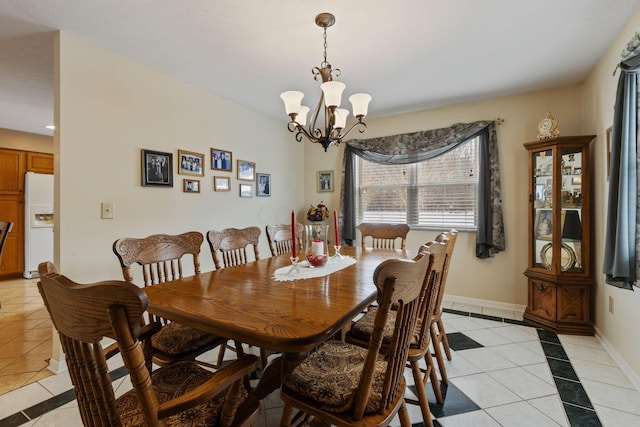 dining space featuring light tile patterned floors and a notable chandelier