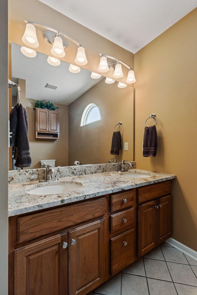 bathroom featuring tile patterned flooring and vanity