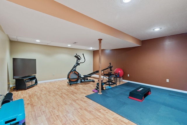 workout room with hardwood / wood-style flooring