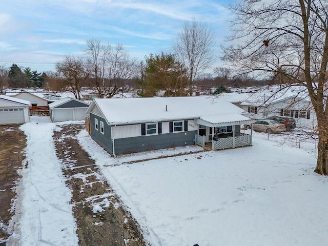 view of front of house featuring a garage and an outbuilding