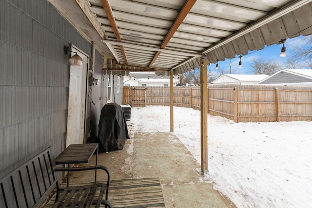 snow covered patio featuring cooling unit