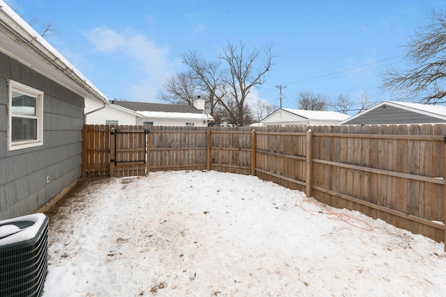 yard layered in snow with central AC unit