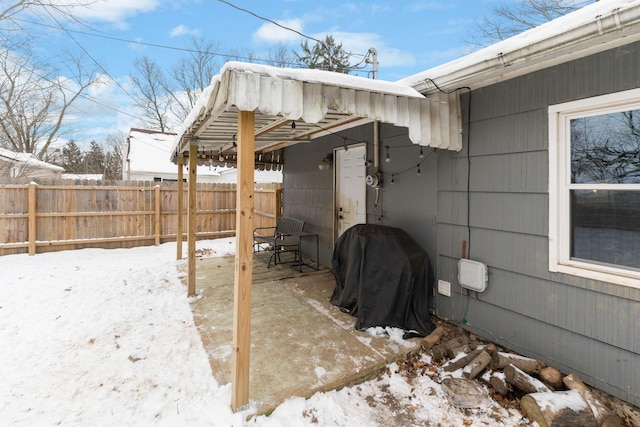 snow covered patio with area for grilling