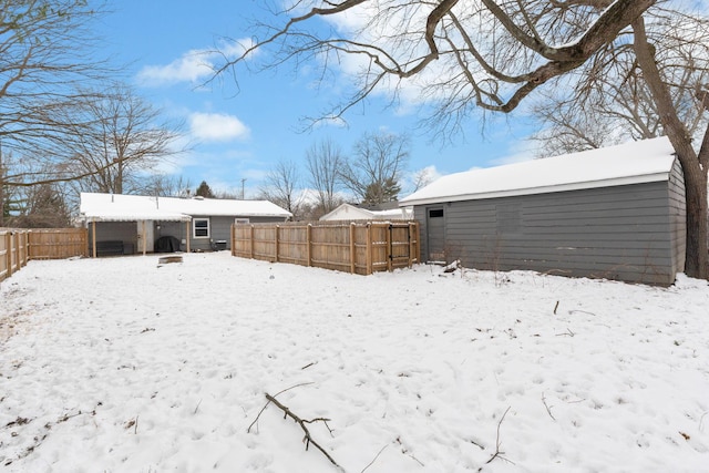 snowy yard featuring an outdoor structure