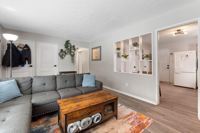 living room featuring a textured ceiling and hardwood / wood-style flooring