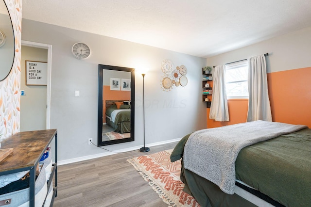 bedroom with hardwood / wood-style flooring