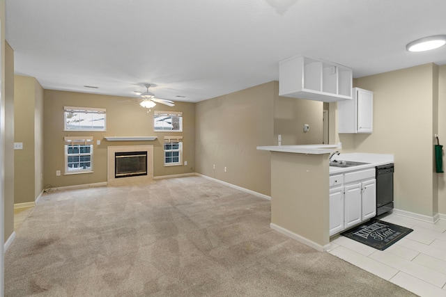 kitchen featuring light carpet, white cabinets, ceiling fan, sink, and dishwasher