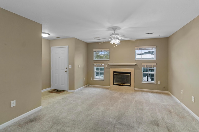 unfurnished living room with ceiling fan and light carpet