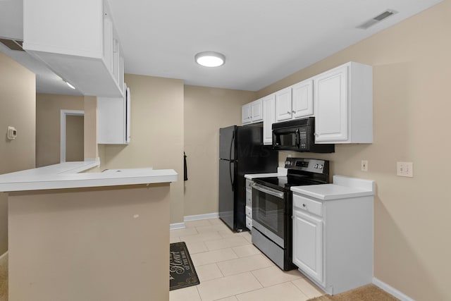 kitchen with kitchen peninsula, black appliances, white cabinetry, a breakfast bar area, and light tile patterned flooring