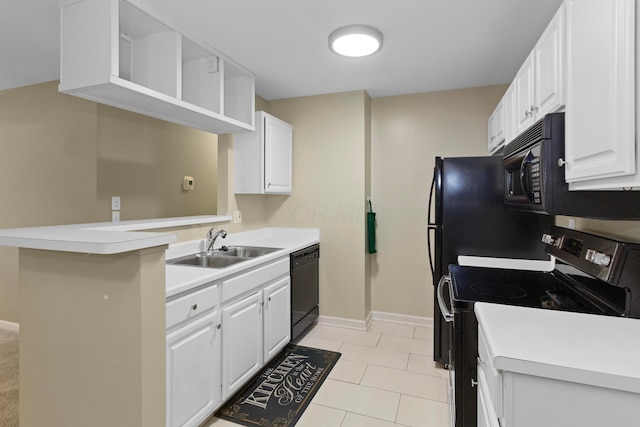 kitchen featuring kitchen peninsula, sink, black appliances, light tile patterned floors, and white cabinetry