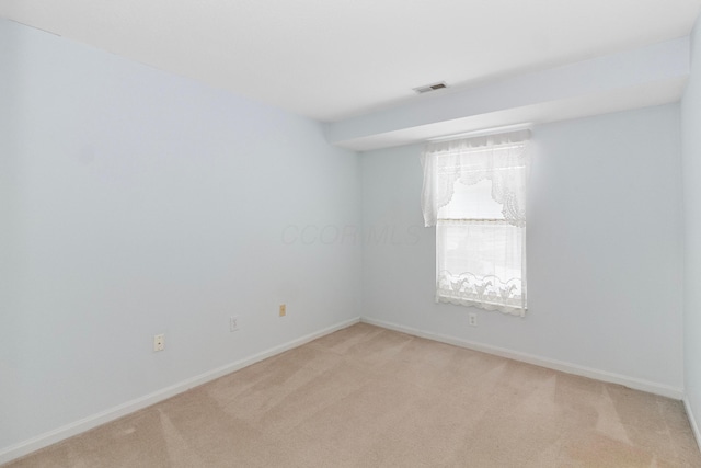 unfurnished room with light colored carpet