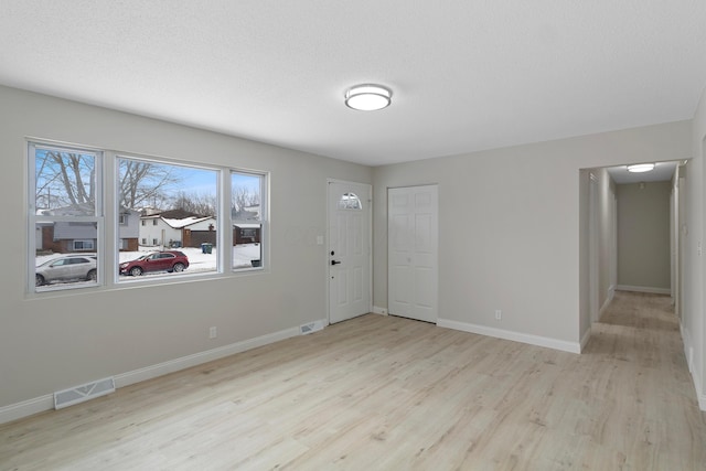 unfurnished room with light wood-type flooring