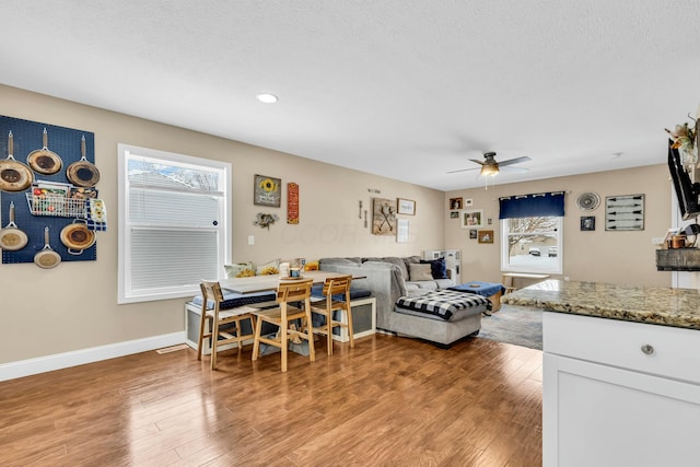 interior space with hardwood / wood-style flooring, ceiling fan, and a textured ceiling