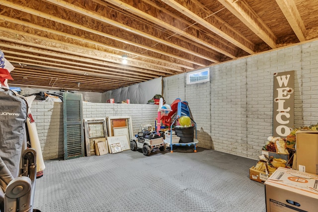 basement featuring brick wall