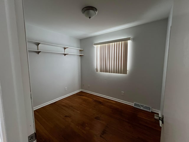 unfurnished room featuring dark hardwood / wood-style flooring