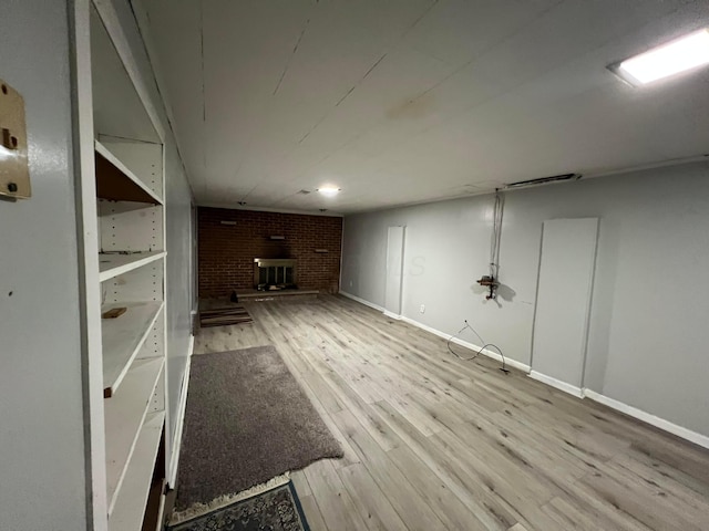 basement featuring hardwood / wood-style flooring and a fireplace