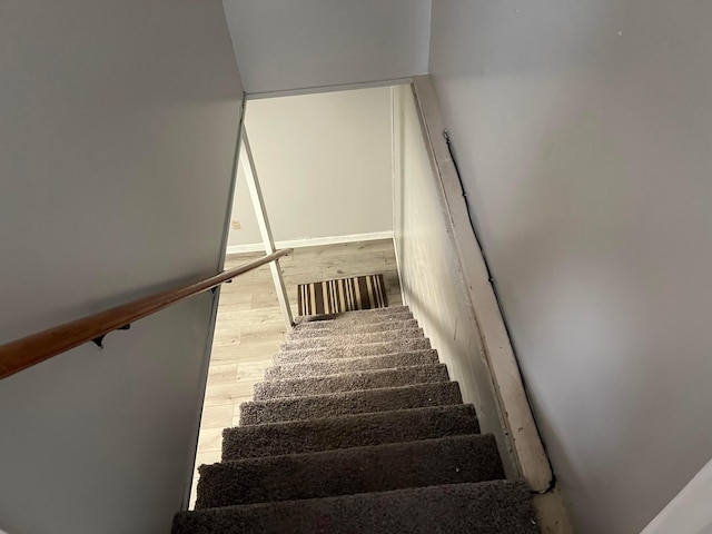 stairs with hardwood / wood-style floors