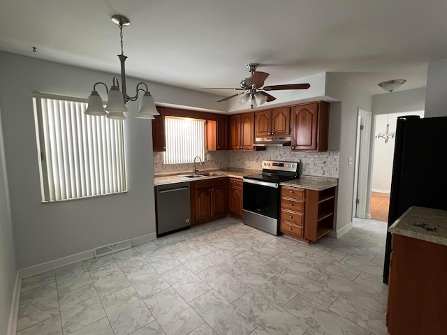 kitchen featuring backsplash, ceiling fan with notable chandelier, hanging light fixtures, and black appliances