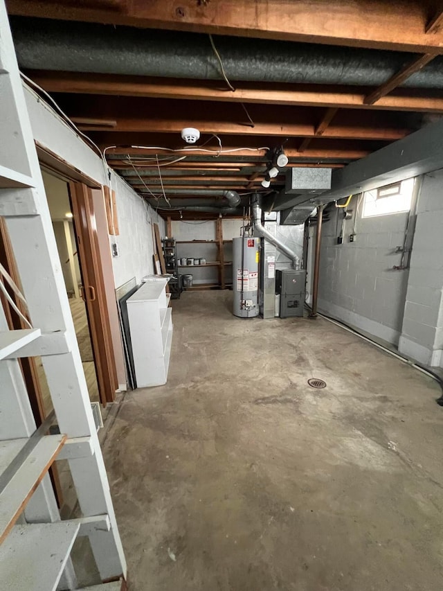 basement with water heater and heating unit